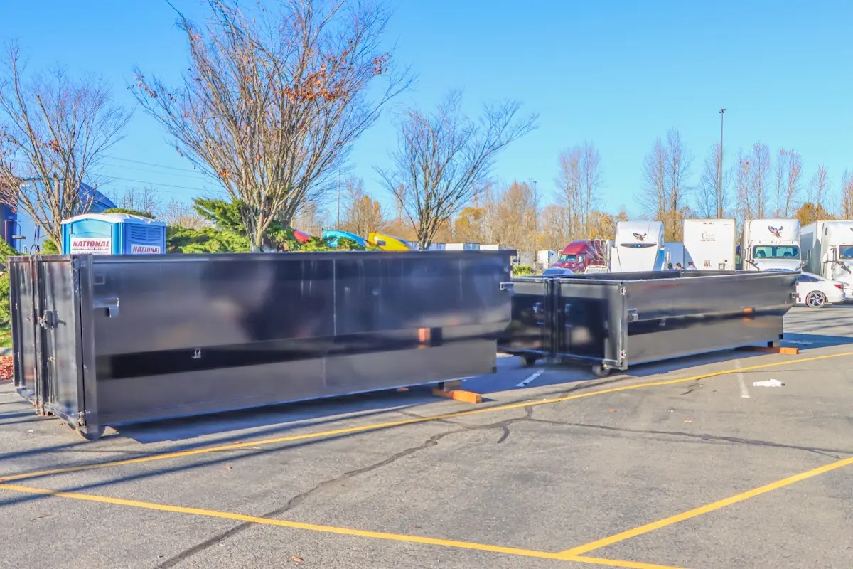 Professional dumpster rental service with roll-off container on residential driveway in Toms River